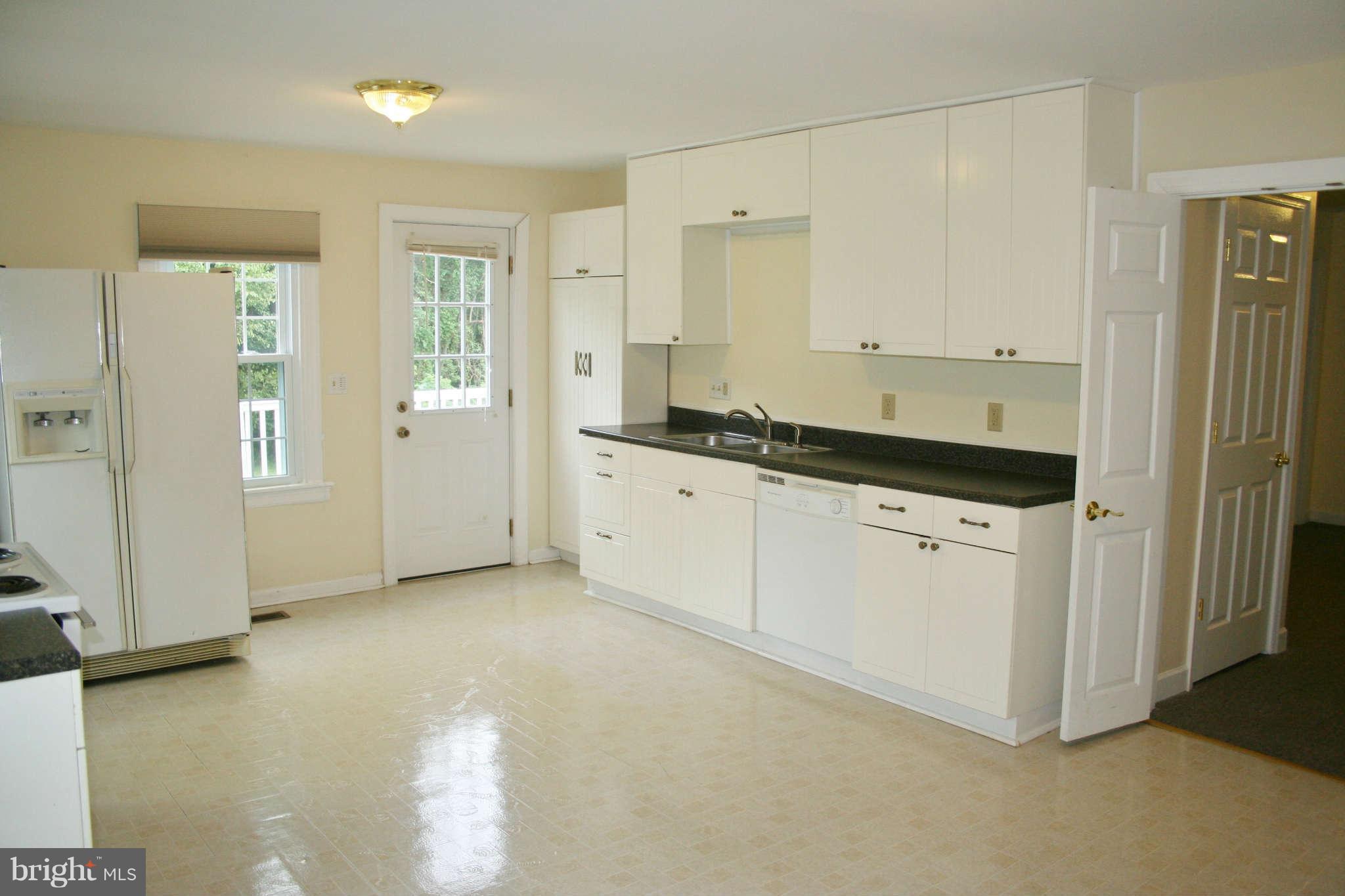 10529 Old Court Road Woodstock, MD 21163 - Photo 12 of 26 a kitchen with granite countertop a sink and cabinets