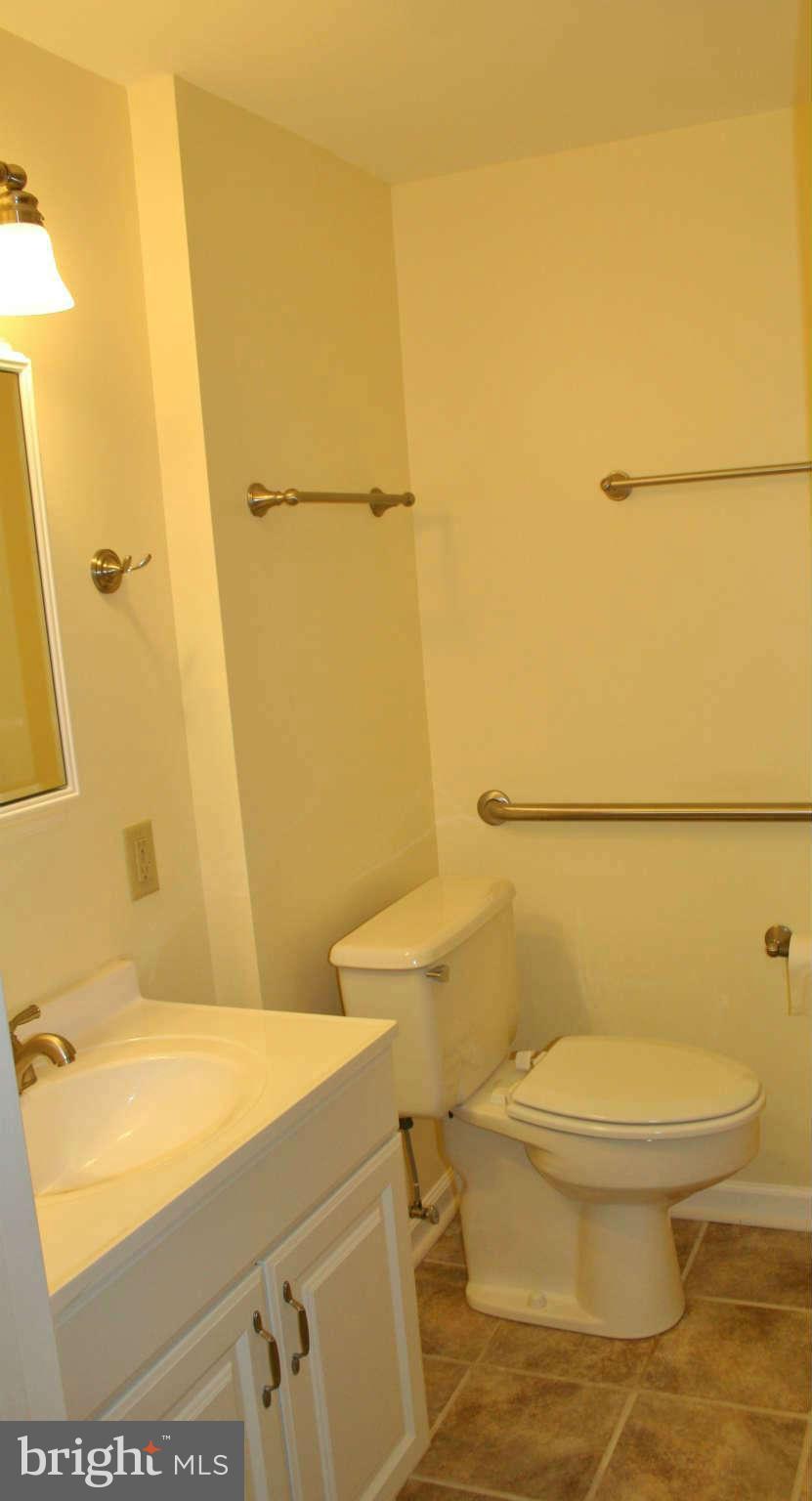 10529 Old Court Road Woodstock, MD 21163 - Photo 15 of 26 a bathroom with a granite countertop toilet and a sink