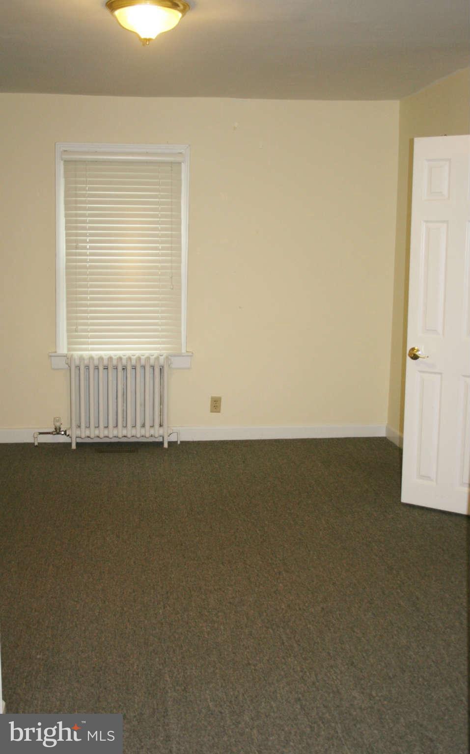 10529 Old Court Road Woodstock, MD 21163 - Photo 10 of 26 an empty room with wooden floor