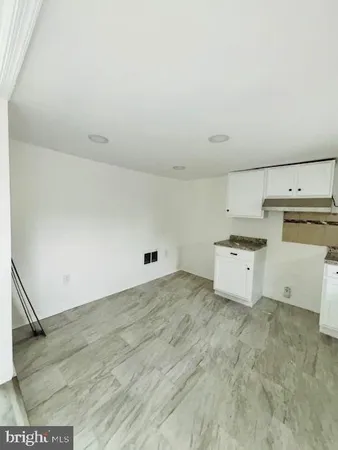 a view of a storage & utility room with cabinets