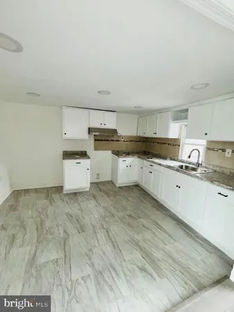 a kitchen with cabinets and white appliances