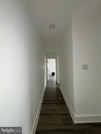 a view of a hallway with the wooden floor