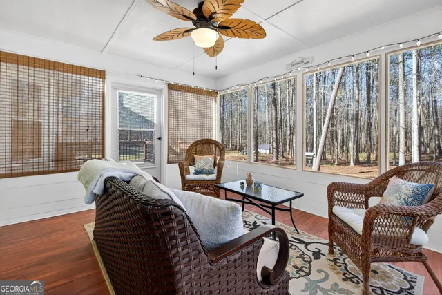 a living room with furniture a chandelier and a window