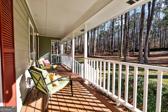 a view of a chairs and table in the balcony