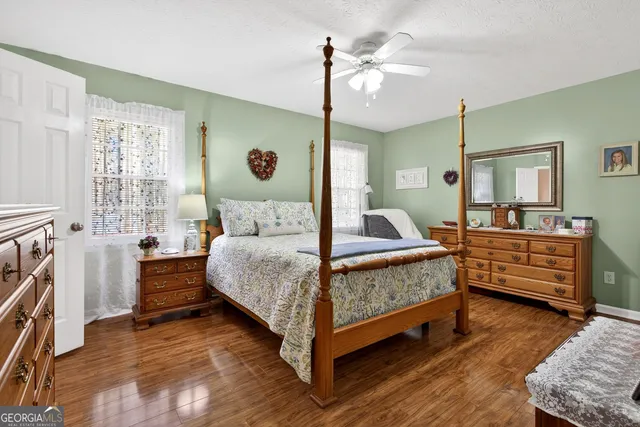 a bedroom with a large bed and a chandelier
