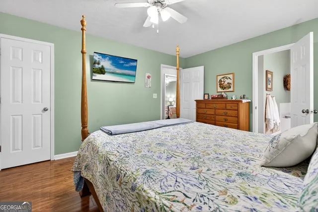 a view of bathroom with a sink and mirror with toilet