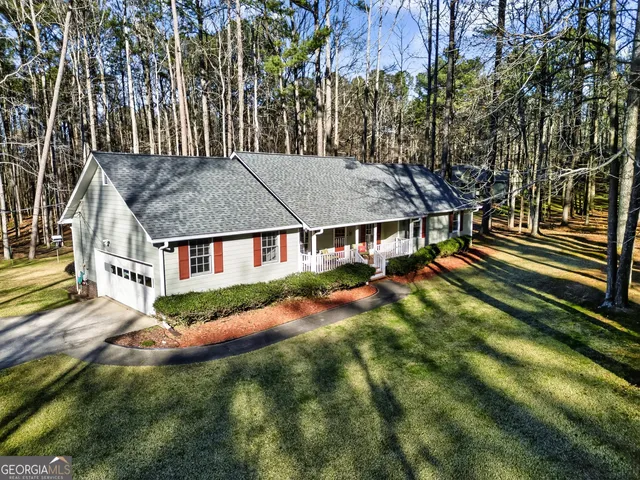 an aerial view of a house with a big yard