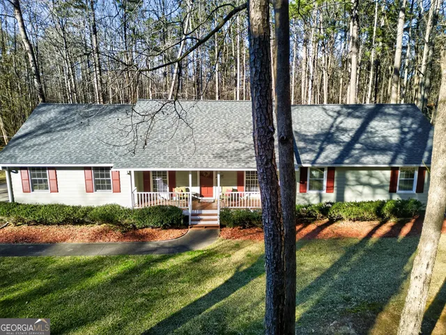 aerial view of a house with a yard table and chairs