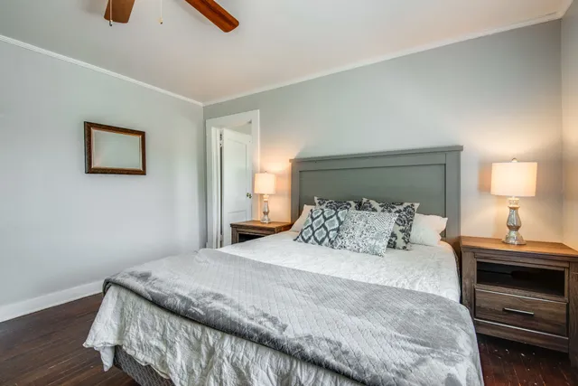 a bedroom with a bed and a lamp on table