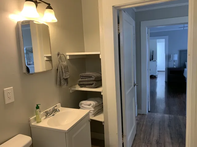 a bathroom with a sink mirror and toilet
