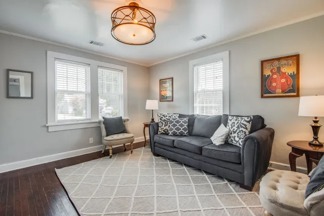 a living room with furniture a bed and a window