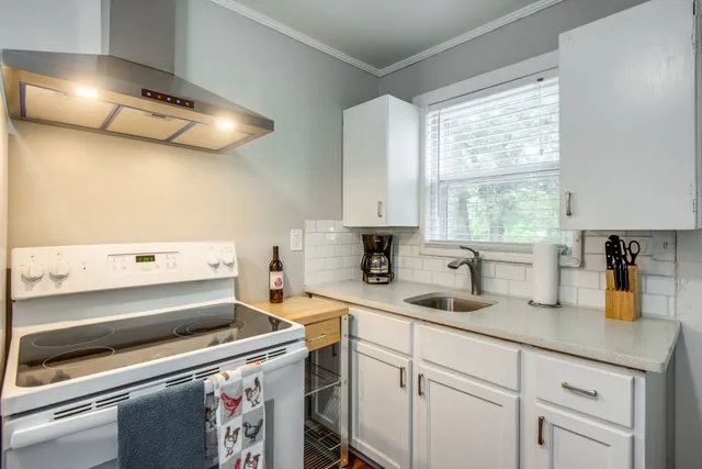a kitchen with a sink cabinets and window
