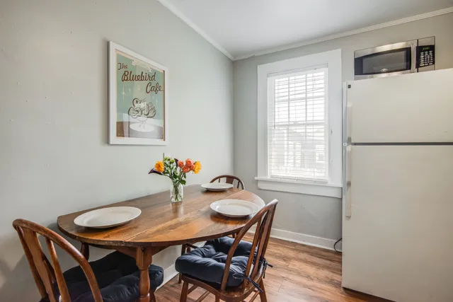 a view of a dining room with furniture and wooden floor