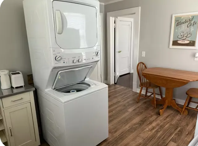 a view of washer and dryer with wooden floor