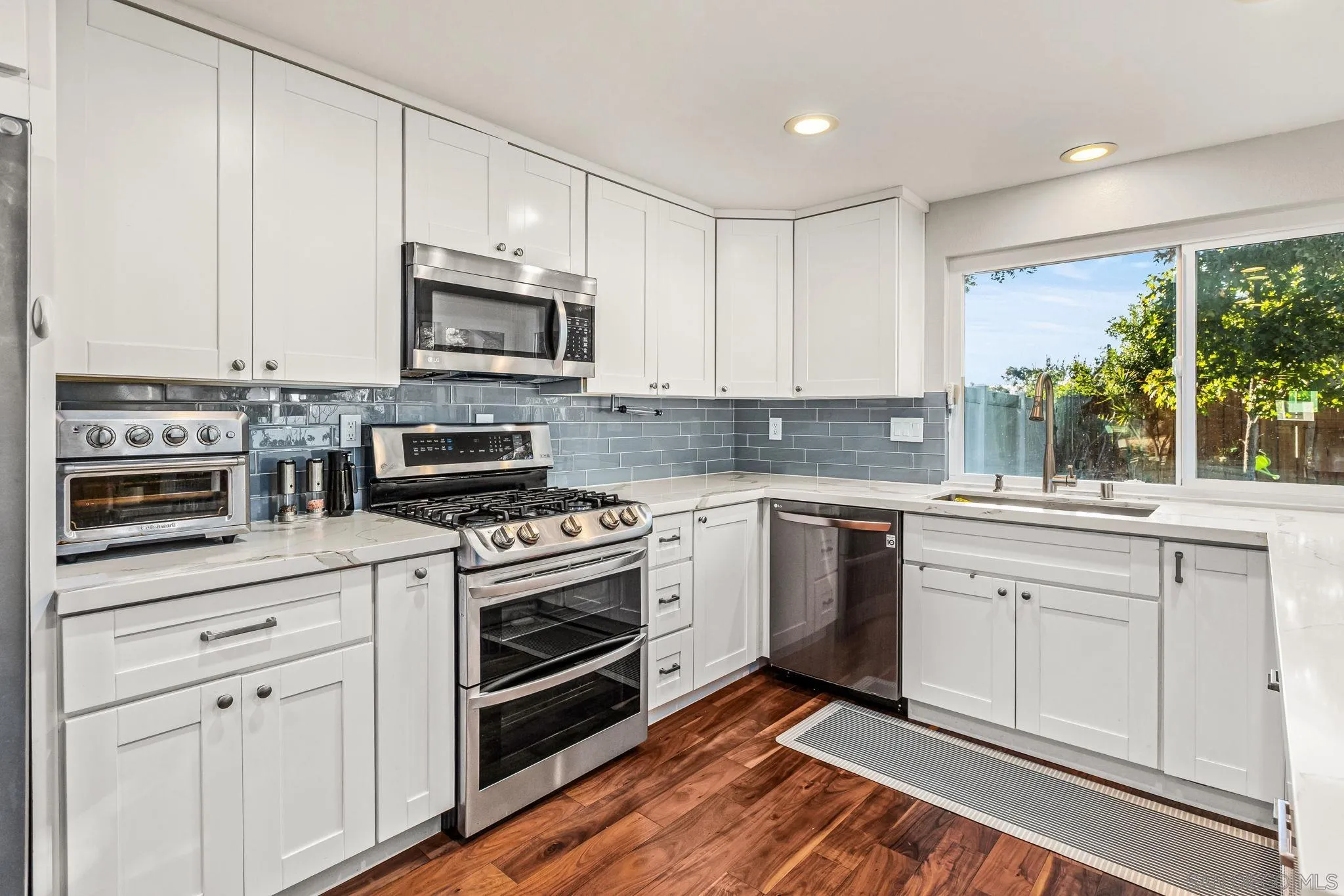 10831 Ironwood Road Scripps Ranch, CA 92131 - Photo 2 of 25 a kitchen with cabinets stainless steel appliances and a sink
