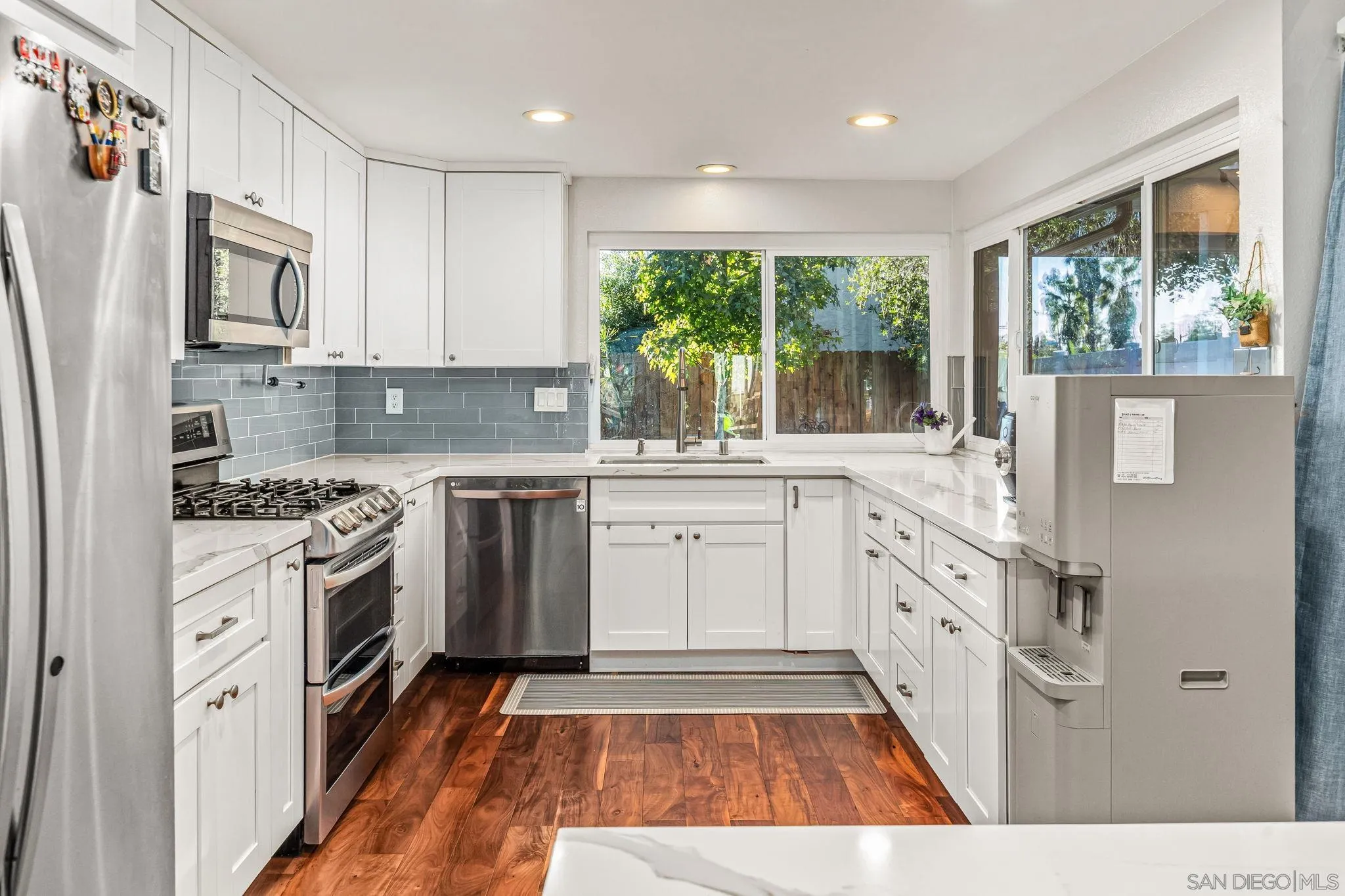 10831 Ironwood Road Scripps Ranch, CA 92131 - Photo 3 of 25 a kitchen with white cabinets and white appliances