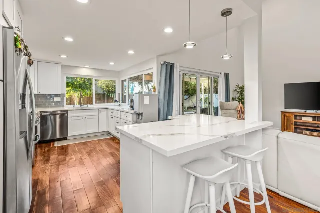 a large kitchen with kitchen island a large counter top space appliances and a center island