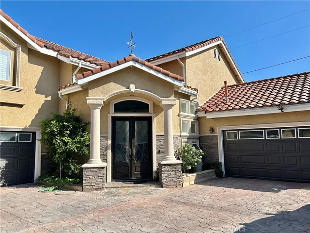 a view of a house with a yard and a garage