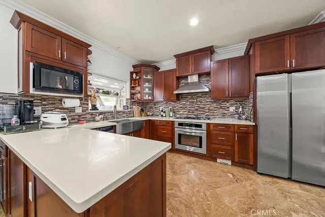 a kitchen with stainless steel appliances granite countertop a stove a sink dishwasher and a refrigerator