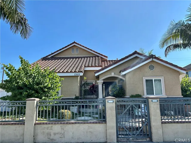 a view of an empty room with wooden floor and window
