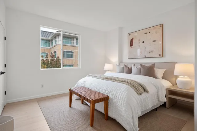 a bedroom with a bed and wooden floor