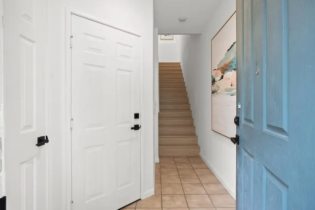 a view of a hallway with wooden floor and staircase
