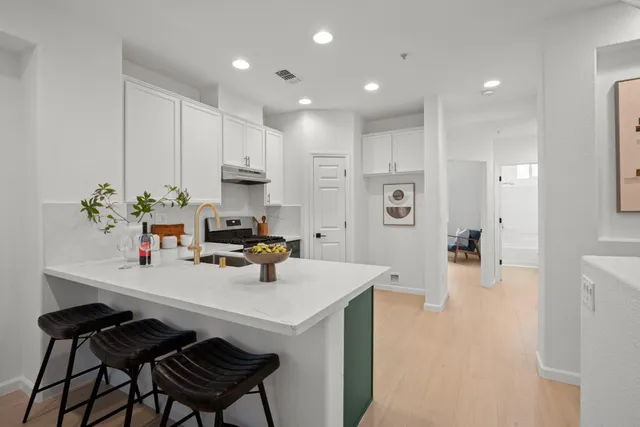 a kitchen with a sink cabinets and wooden floor