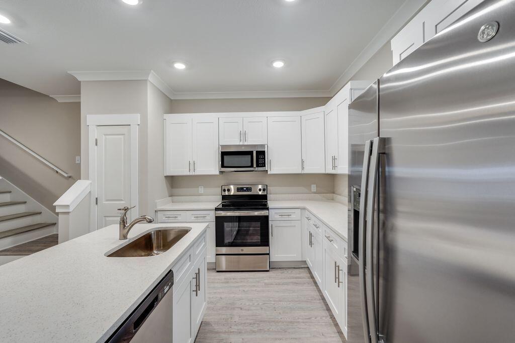60 Date Palm Lane Freeport, FL 32439 - Photo 8 of 26 a kitchen with a sink stove and refrigerator