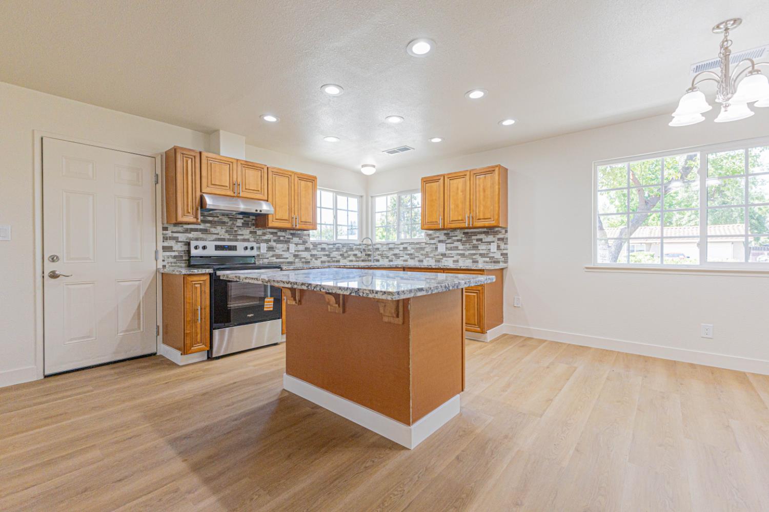 17925 Rodeo Drive Madera, CA 93638 - Photo 5 of 26 a kitchen with stainless steel appliances granite countertop a stove a sink and a microwave