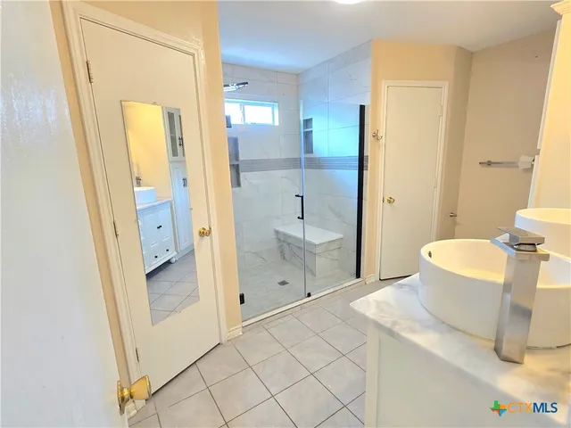 a spacious bathroom with a granite countertop sink a toilet and shower