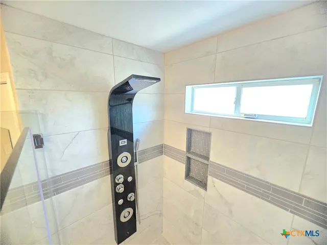 a bathroom with a bathtub and shower