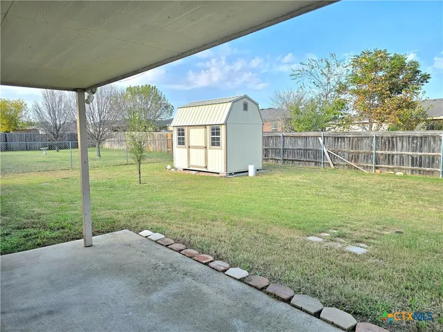 a view of a house with backyard and porch