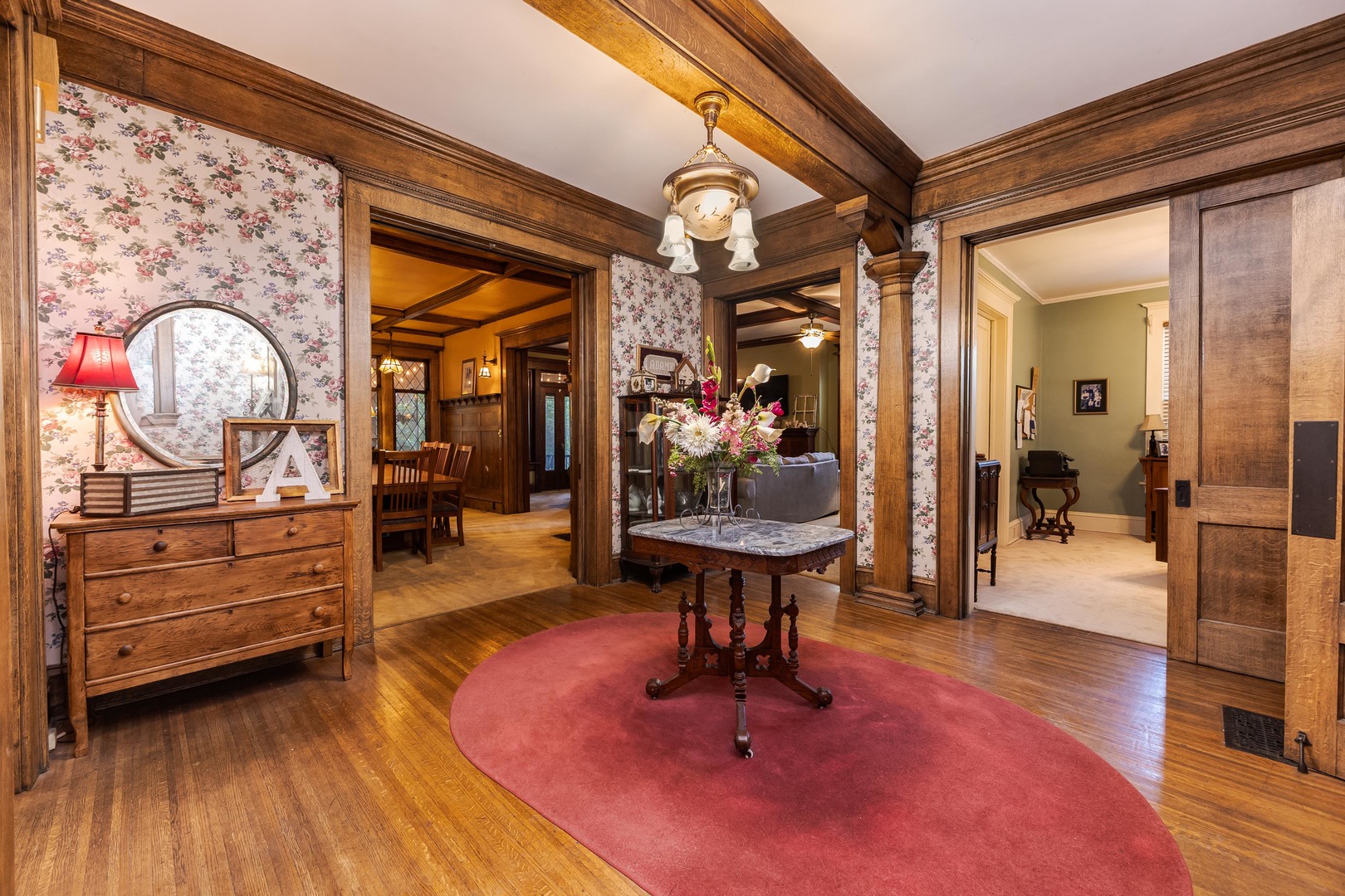 1111 East Grove Street Bloomington, IL 61701 - Photo 11 of 56 a living room with furniture and a chandelier