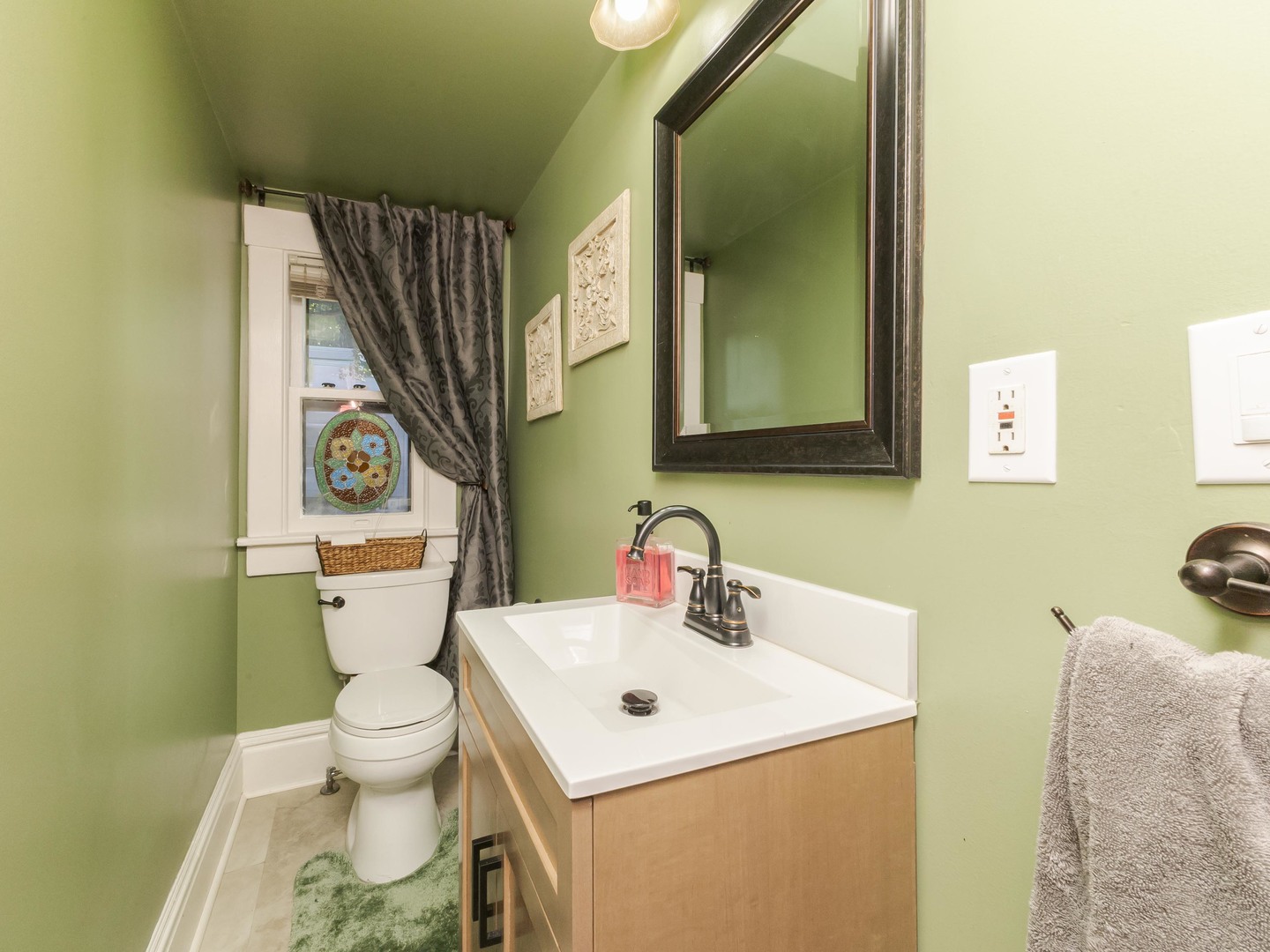 1111 East Grove Street Bloomington, IL 61701 - Photo 27 of 56 a bathroom with a sink mirror vanity and toilet