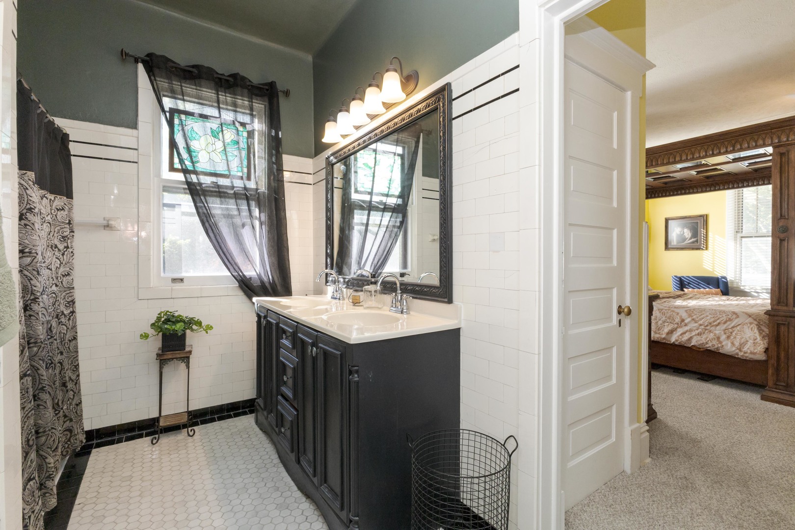 1111 East Grove Street Bloomington, IL 61701 - Photo 34 of 56 a en suite bathroom with a granite countertop sink and a mirror