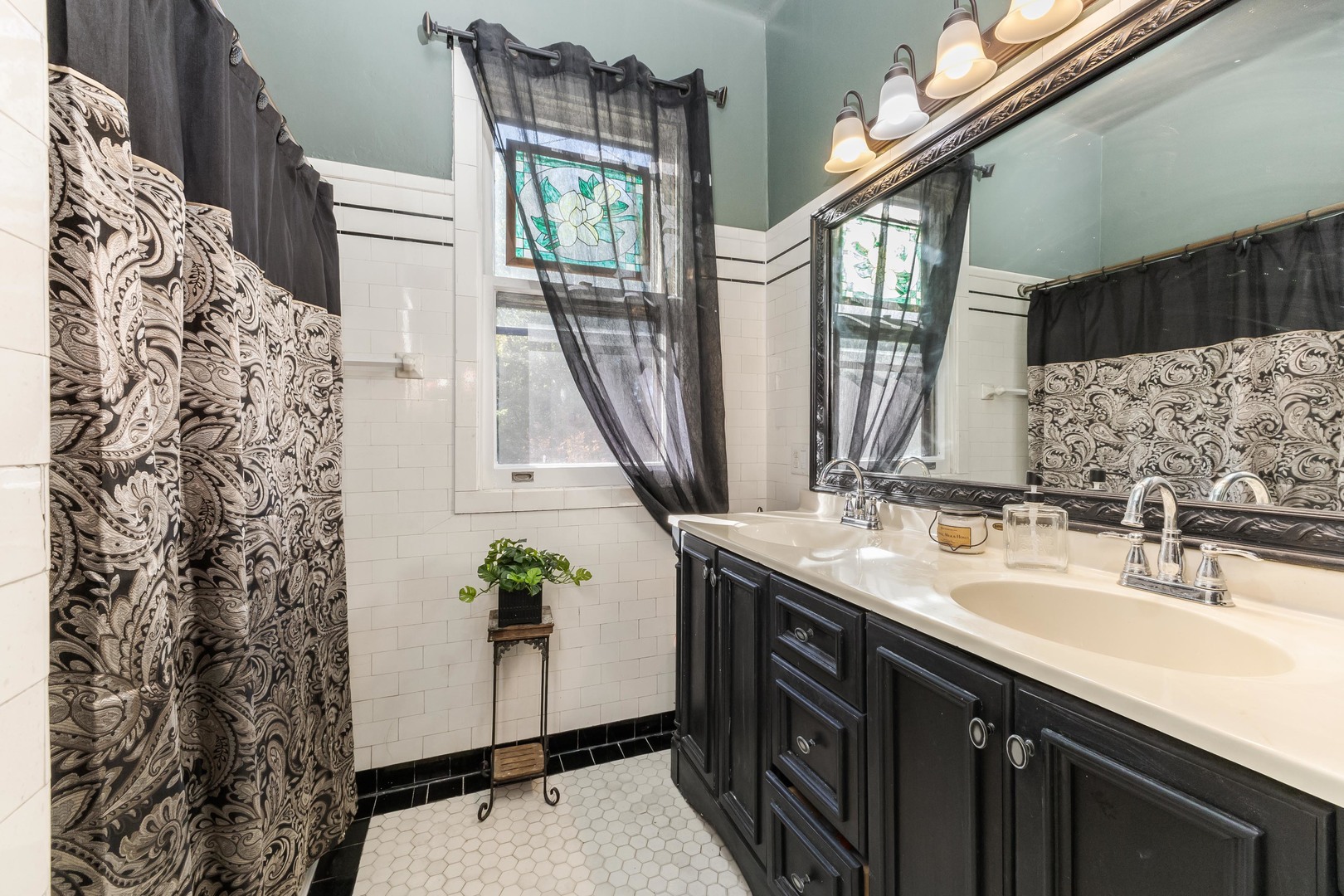 1111 East Grove Street Bloomington, IL 61701 - Photo 35 of 56 a bathroom with a sink and a mirror