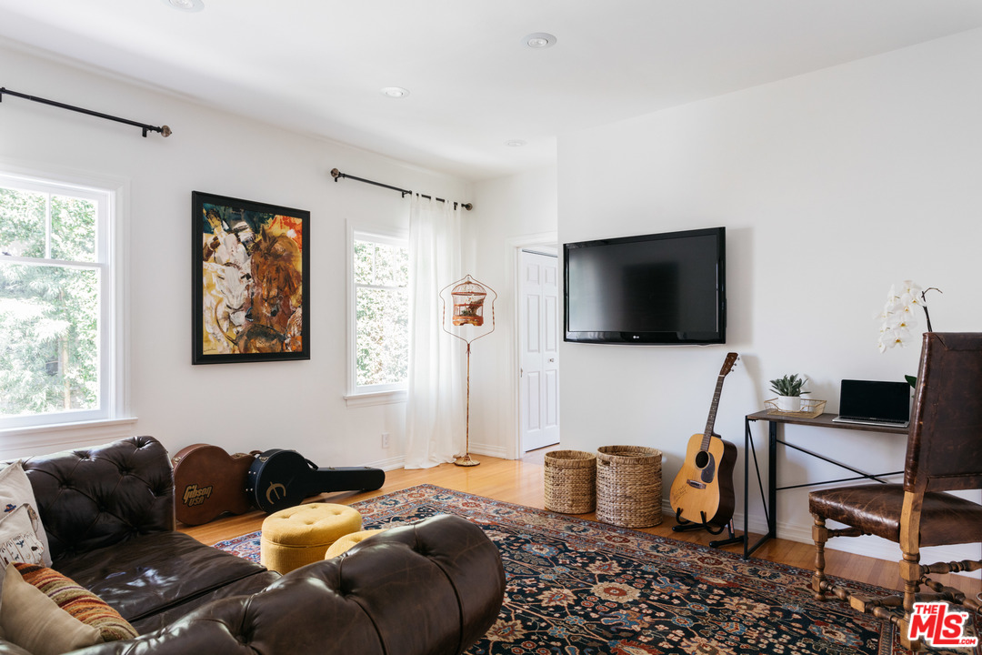 6151 Barrows Drive Los Angeles, CA 90048 - Photo 17 of 25 a bedroom with a bed and a flat screen tv