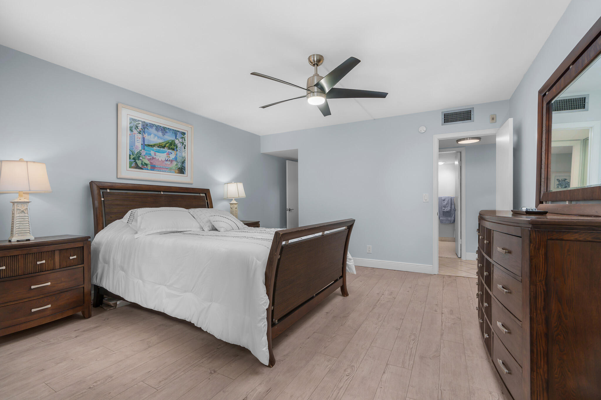 950 Ponce De Leon Road, Unit 207 Boca Raton, FL 33432 - Photo 17 of 36 a spacious bedroom with a bed and a chandelier