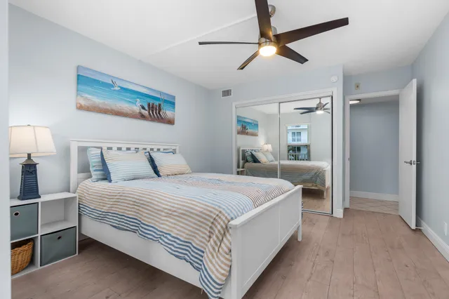 a bedroom with bed and a chandelier