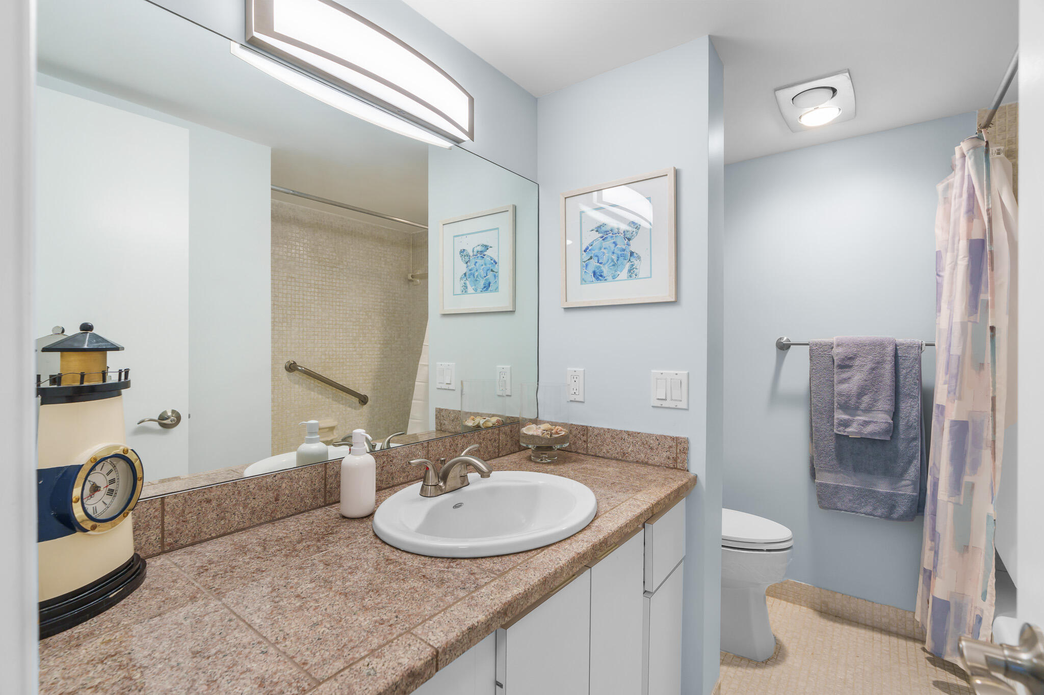950 Ponce De Leon Road, Unit 207 Boca Raton, FL 33432 - Photo 24 of 36 a bathroom with a granite countertop sink a toilet a mirror and shower