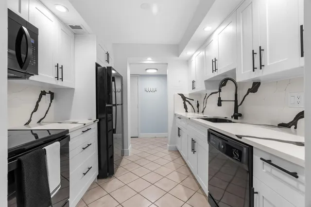 a kitchen with stainless steel appliances a sink stove and refrigerator