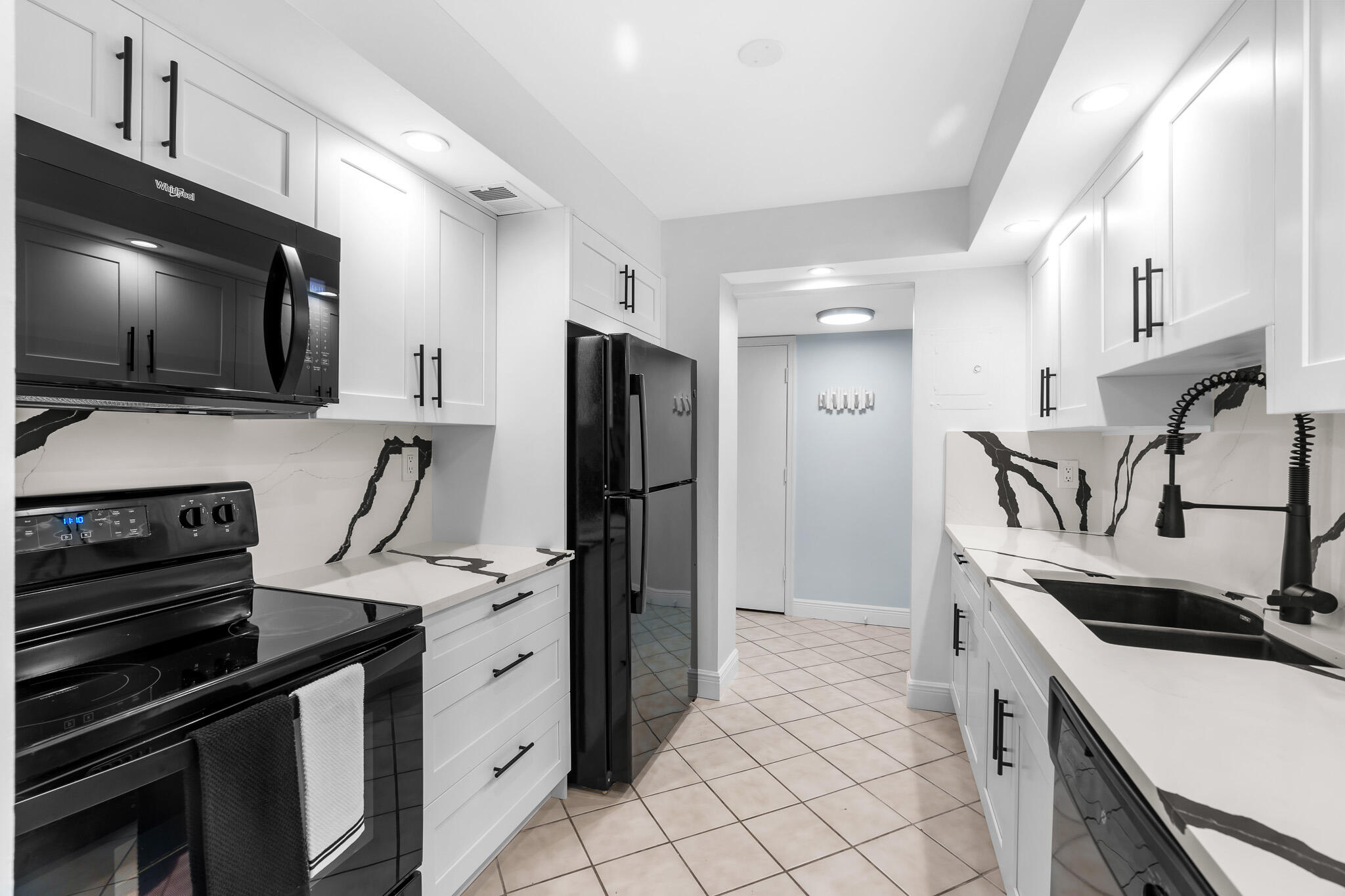 950 Ponce De Leon Road, Unit 207 Boca Raton, FL 33432 - Photo 5 of 36 a kitchen with a sink stove and refrigerator