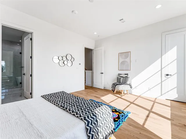 a bedroom with a bed and a large mirror