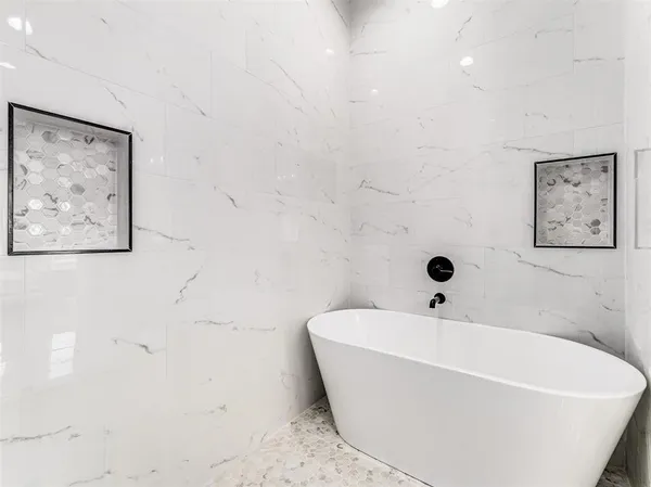 a white bath tub sitting in a bathroom