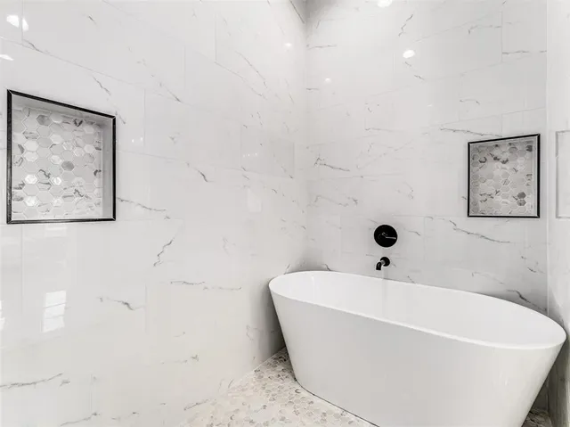 a white bath tub sitting in a bathroom