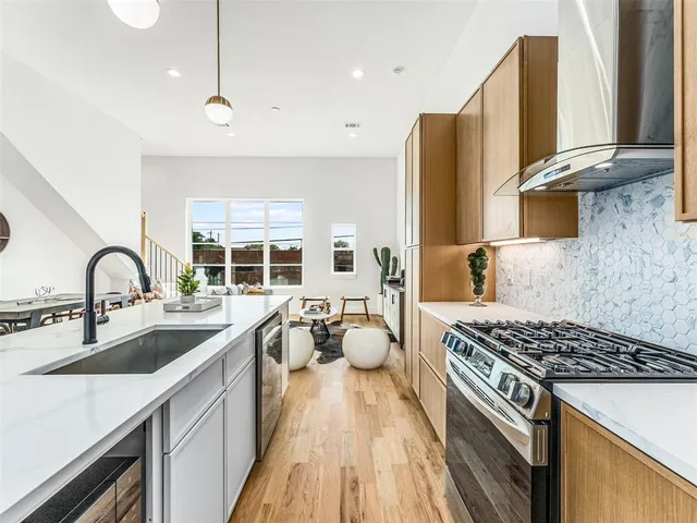 a kitchen with sink a stove and cabinets