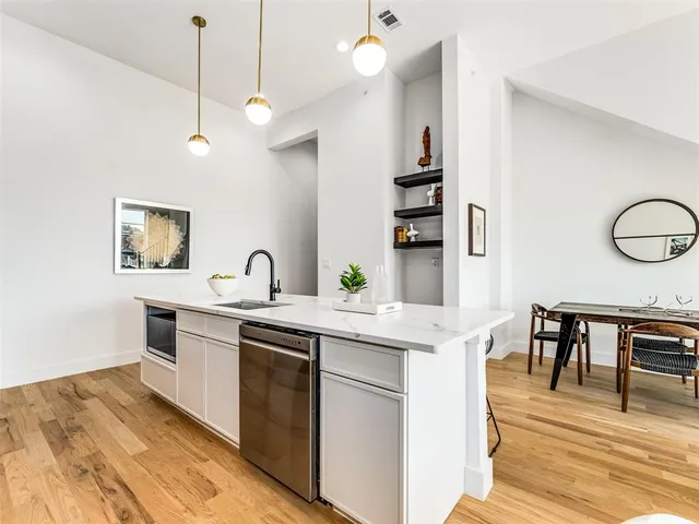 a view of living room with granite countertop furniture and wooden floor