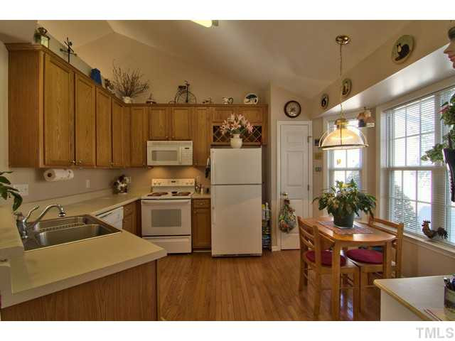 6 Bethany Place Durham, NC 27712 - Photo 4 of 12 a kitchen with a refrigerator and a table