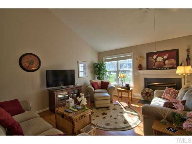 6 Bethany Place Durham, NC 27712 - Photo 5 of 12 a living room with furniture a fireplace and a flat screen tv