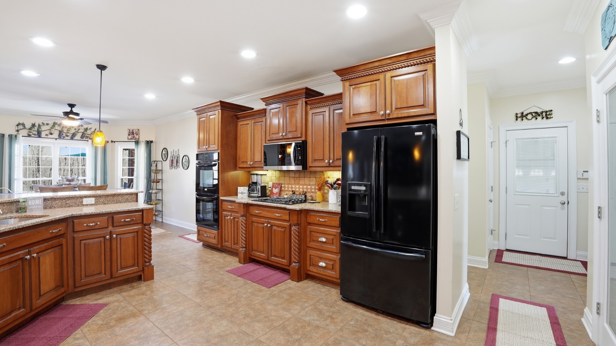 135 Vols Lane Estill Springs, TN 37330 - Photo 13 of 56 a kitchen with stainless steel appliances granite countertop a refrigerator a sink dishwasher and wooden cabinets with wooden floor